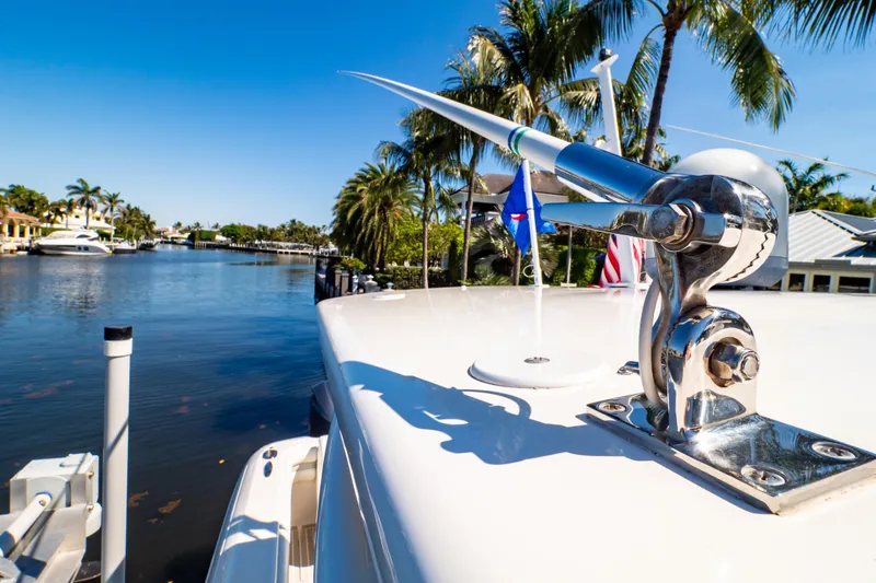 Slide: The Image of 2016 Intrepid 400 Cuddy yacht docked by palm-lined waterfront homes. - 103