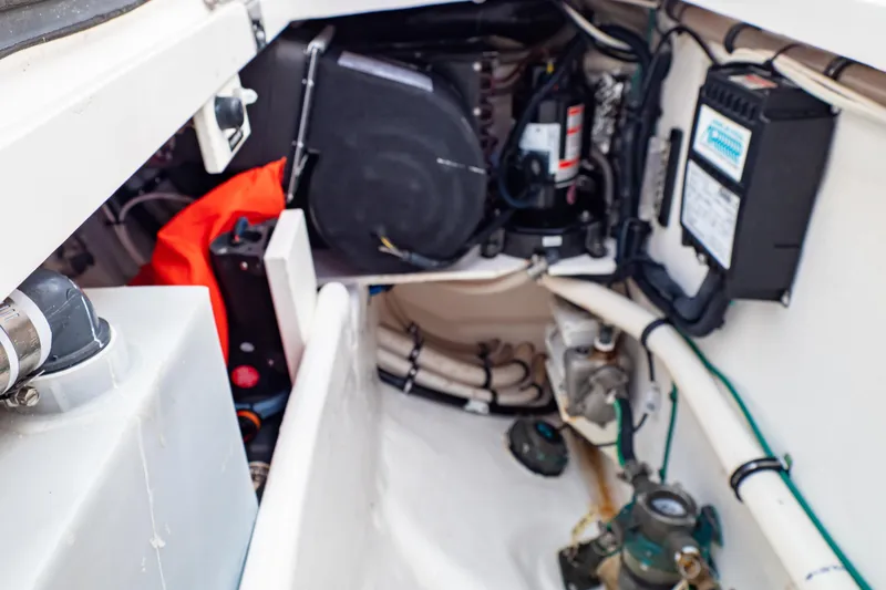 Slide: The Image of Engine compartment of a 2016 Intrepid 400 Cuddy boat, showcasing mechanical components. - 106