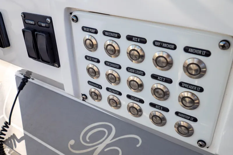 Slide: The Image of Control panel on a 2016 Intrepid 400 Cuddy boat with labeled buttons. - 107