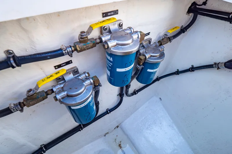 Slide: The Image of Fuel filters and hoses in a 2016 Intrepid 400 Cuddy boat engine compartment. - 109