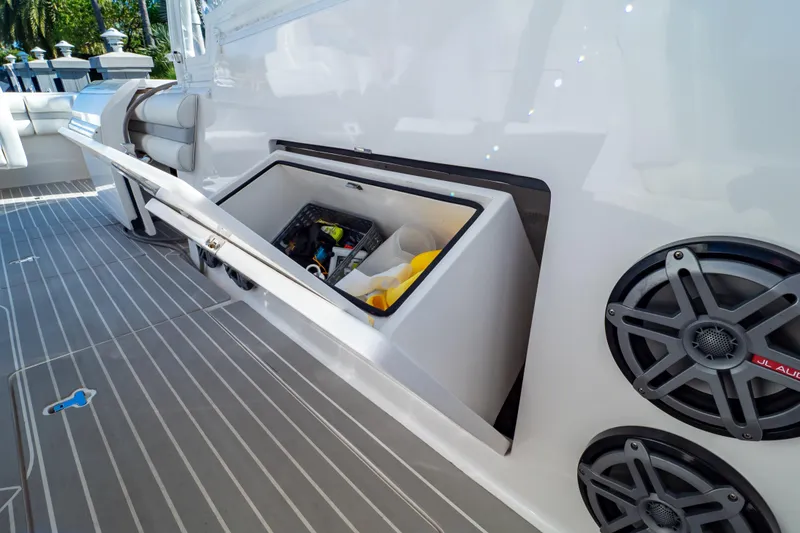 Slide: The Image of 2016 Intrepid 400 Cuddy boat deck with storage compartment and speakers. - 110
