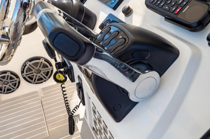 Slide: The Image of Control panel of a 2016 Intrepid 400 Cuddy boat with steering and electronics. - 111