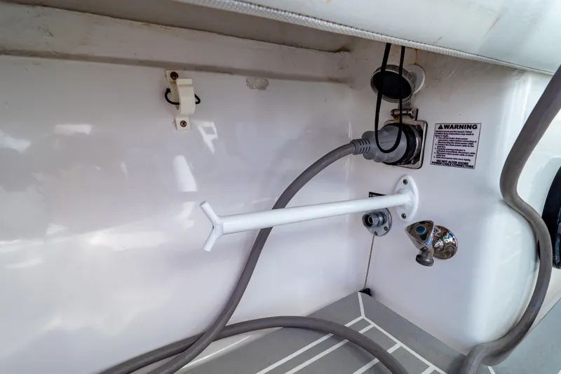 Slide: The Image of 2016 Intrepid 400 Cuddy boat interior with cables and warning label. - 112