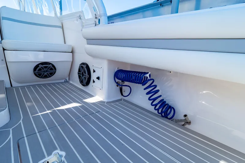 Slide: The Image of Interior of 2016 Intrepid 400 Cuddy boat with seating and coiled hose. - 114