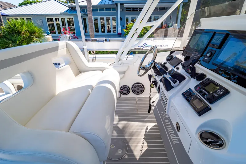 Slide: The Image of Cockpit of 2016 Intrepid 400 Cuddy with modern navigation equipment and plush seating. - 12