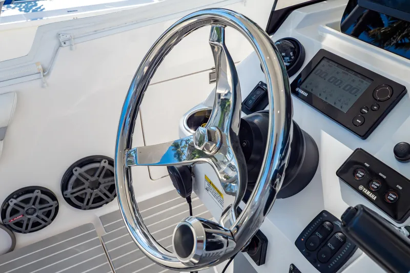 Slide: The Image of Steering wheel and controls of 2016 Intrepid 400 Cuddy boat cockpit. - 120