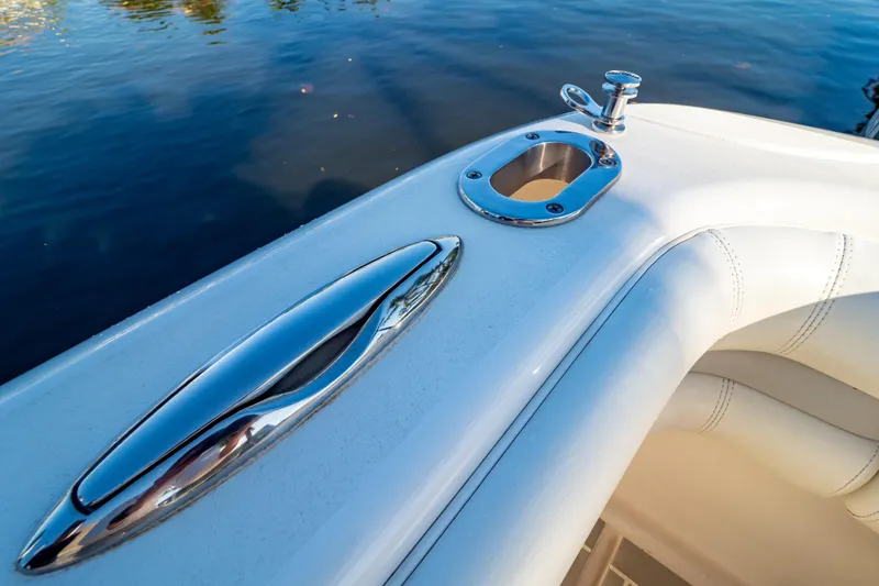 Slide: The Image of Close-up of 2016 Intrepid 400 Cuddy boat's sleek chrome fittings and white upholstery. - 124