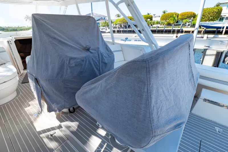 Slide: The Image of 2016 Intrepid 400 Cuddy boat interior with covered seats and sleek design. - 142