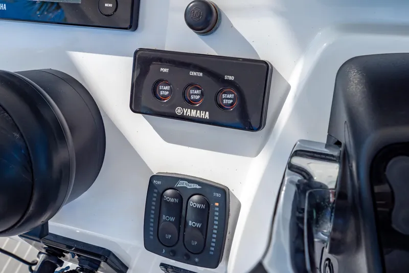Slide: The Image of Control panel of a 2016 Intrepid 400 Cuddy boat with Yamaha start-stop buttons. - 17
