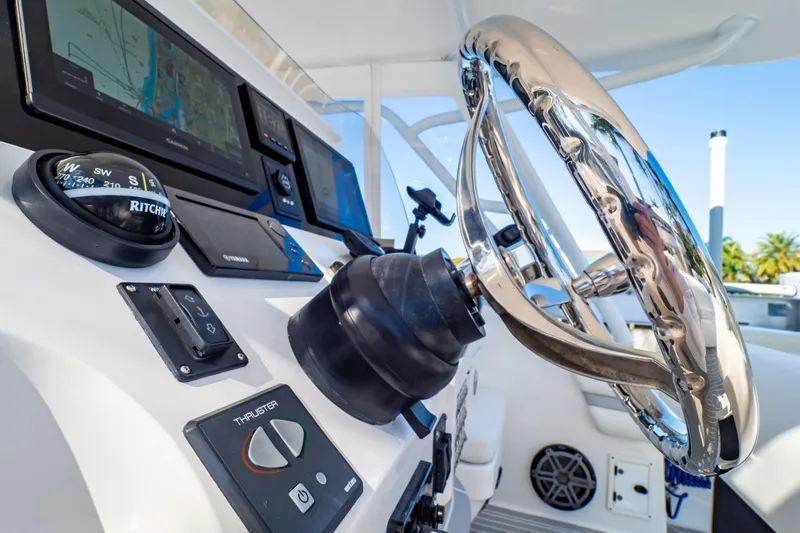 Slide: The Image of 2016 Intrepid 400 Cuddy helm with steering wheel and navigation instruments. - 18