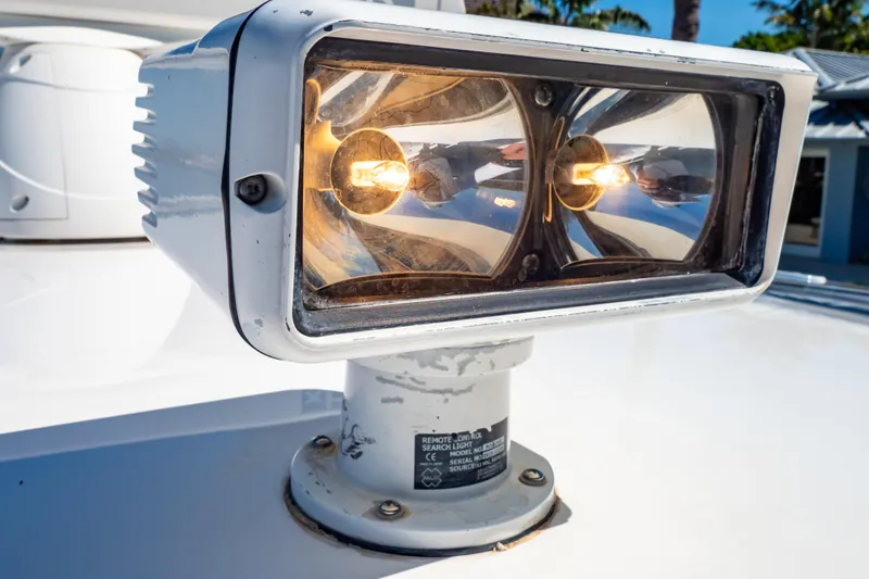 Slide: The Image of Close-up of a 2016 Intrepid 400 Cuddy boat spotlight, illuminated and mounted on deck. - 34