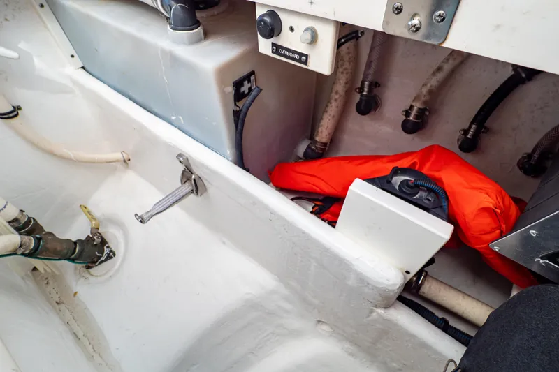 Slide: The Image of Interior view of a 2016 Intrepid 400 Cuddy boat showing storage compartment and safety equipment. - 35