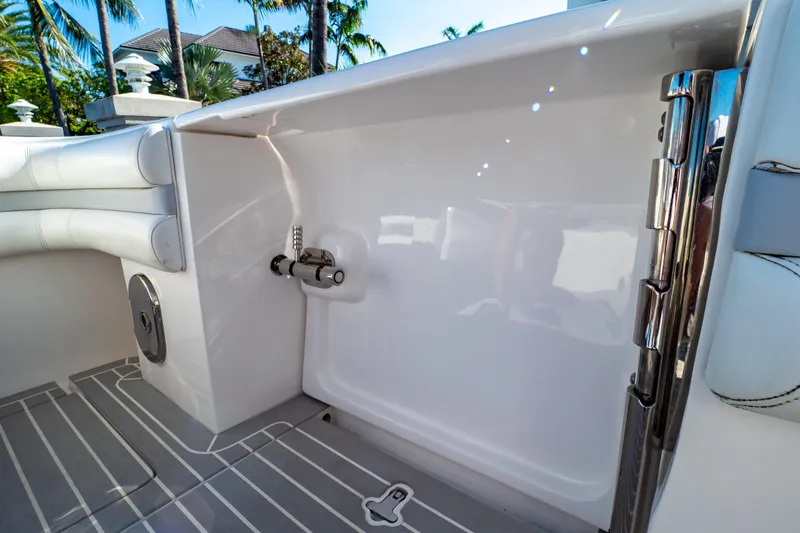 Slide: The Image of 2016 Intrepid 400 Cuddy boat interior with sleek white seating and stainless steel fixtures. - 40