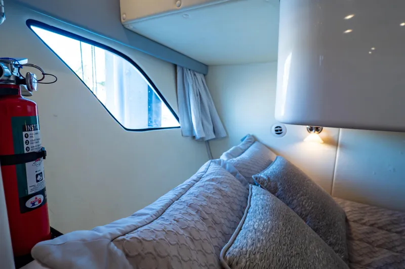 Slide: The Image of Cozy cabin interior of 2016 Intrepid 400 Cuddy with pillows and a fire extinguisher. - 41