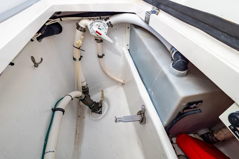 Slide: The Image of 2016 Intrepid 400 Cuddy boat plumbing system with diverter valve and storage tank. - 42