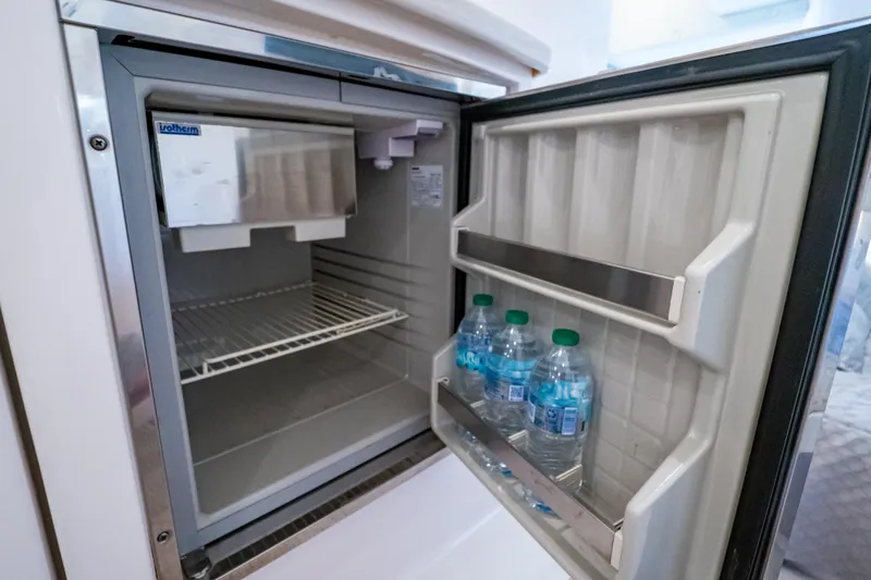 Slide: The Image of Open refrigerator on 2016 Intrepid 400 Cuddy boat, containing water bottles. - 45