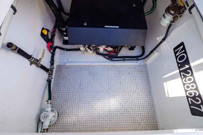 Slide: The Image of Engine compartment of a 2016 Intrepid 400 Cuddy boat, showing mechanical components and wiring. - 48