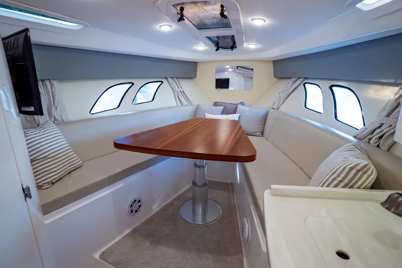 Slide: The Image of Luxurious interior of 2016 Intrepid 400 Cuddy boat with cozy seating and elegant table. - 5
