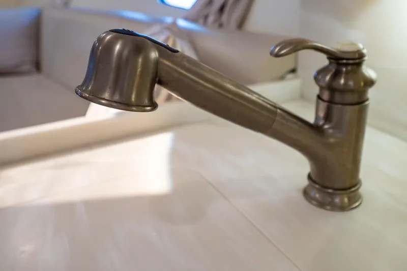 Slide: The Image of Close-up of a metallic faucet in a 2016 Intrepid 400 Cuddy boat interior. - 52