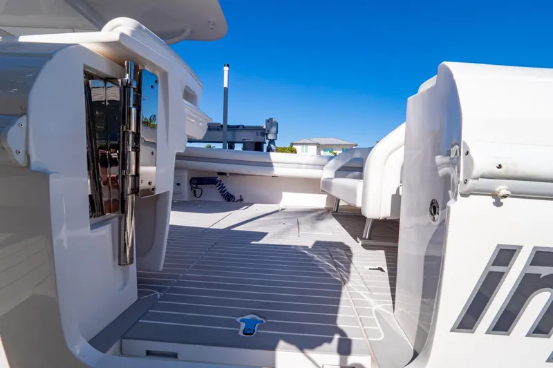 Slide: The Image of 2016 Intrepid 400 Cuddy boat deck with sleek design and modern features under clear blue sky. - 55
