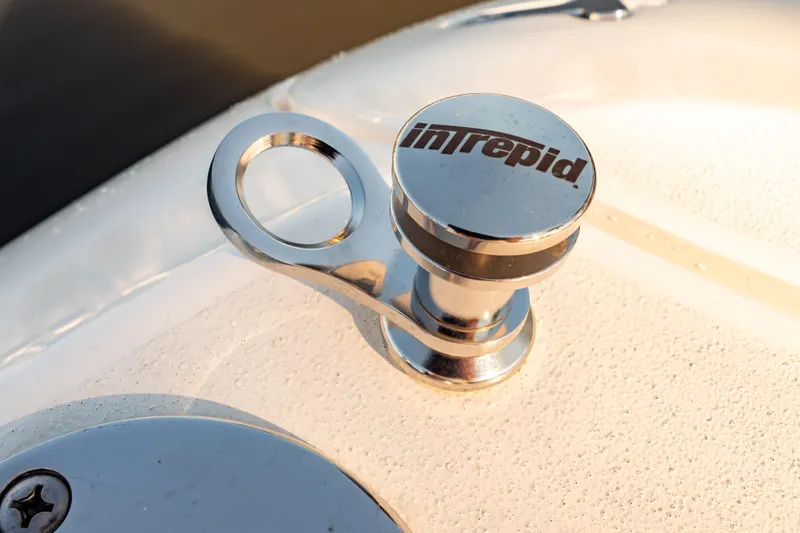 Slide: The Image of Close-up of a 2016 Intrepid 400 Cuddy boat cleat with logo. - 57