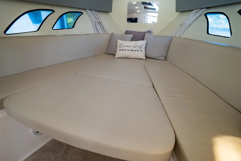Slide: The Image of Luxurious interior of 2016 Intrepid 400 Cuddy with beige seating and decorative pillows. - 6