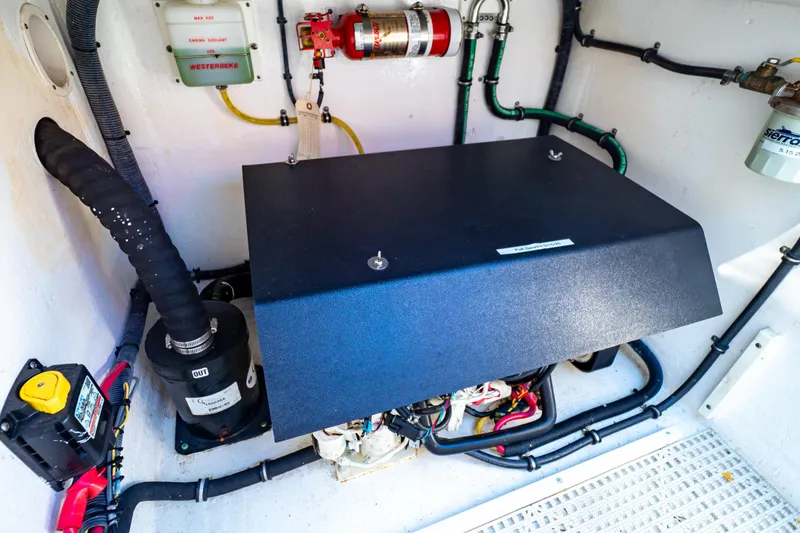 Slide: The Image of Engine compartment of a 2016 Intrepid 400 Cuddy boat, showcasing mechanical components. - 69