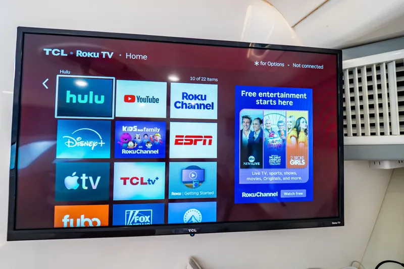 Slide: The Image of TCL Roku TV displaying streaming apps like Hulu, YouTube, and Disney+ on Intrepid 400 Cuddy. - 74
