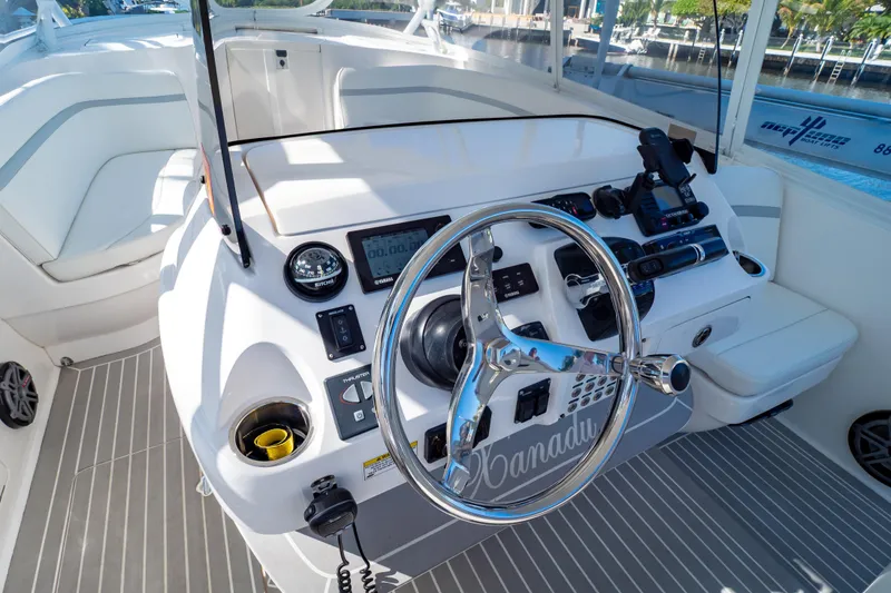 Slide: The Image of Steering console of 2016 Intrepid 400 Cuddy boat with modern controls and seating. - 78