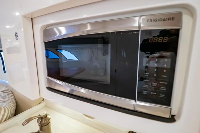 Slide: The Image of Frigidaire microwave in 2016 Intrepid 400 Cuddy boat interior kitchen area. - 83