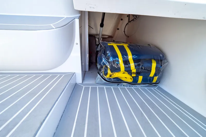 Slide: The Image of Storage compartment in 2016 Intrepid 400 Cuddy boat with safety equipment. - 86