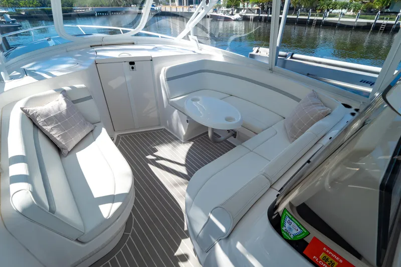 Slide: The Image of Luxurious 2016 Intrepid 400 Cuddy boat interior with white seating and table. - 88