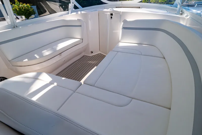Slide: The Image of Luxurious seating area on a 2016 Intrepid 400 Cuddy boat, featuring white upholstery. - 89