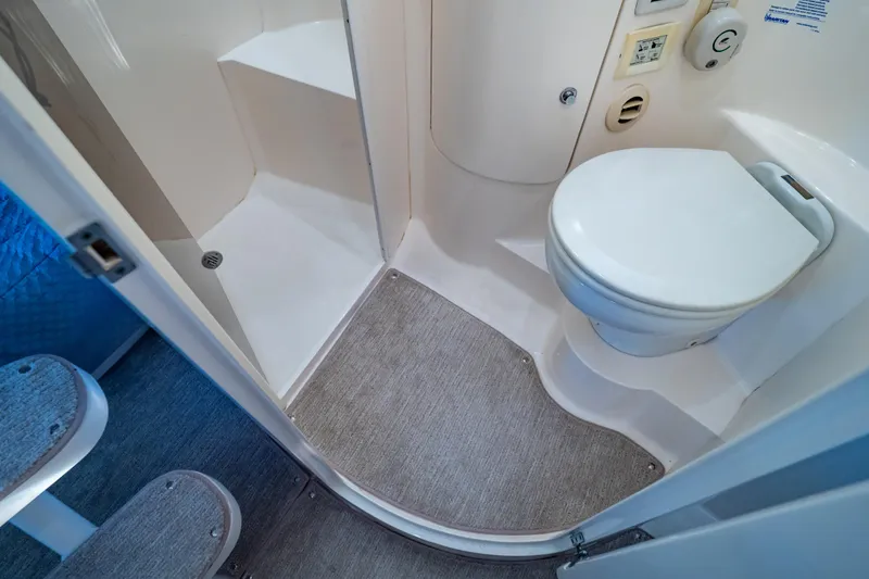 Slide: The Image of Bathroom interior of 2016 Intrepid 400 Cuddy boat, featuring toilet and shower area. - 9