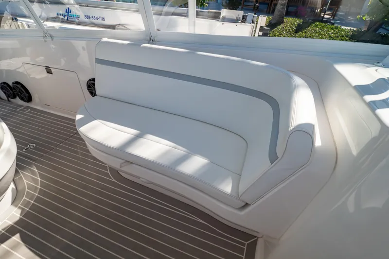 Slide: The Image of 2016 Intrepid 400 Cuddy boat interior with white cushioned seating and striped flooring. - 92