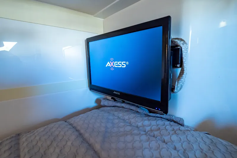 Slide: The Image of Axess TV in 2016 Intrepid 400 Cuddy cabin, mounted on wall above bed. - 97