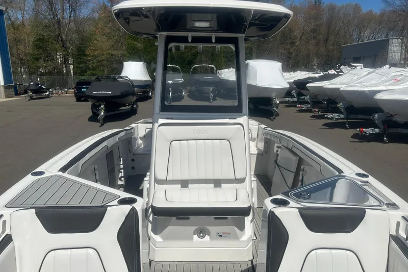 Slide: The Image of 2024 Yamaha Boats 252 FSH Sport, sleek design, spacious seating, outdoor showroom display. - 12