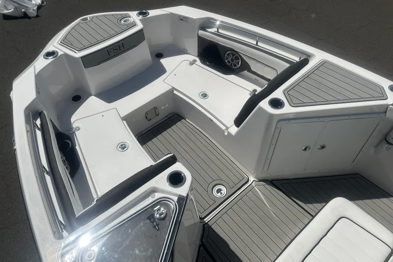 Slide: The Image of 2024 Yamaha Boats 252 FSH Sport interior with seating and storage compartments. - 13