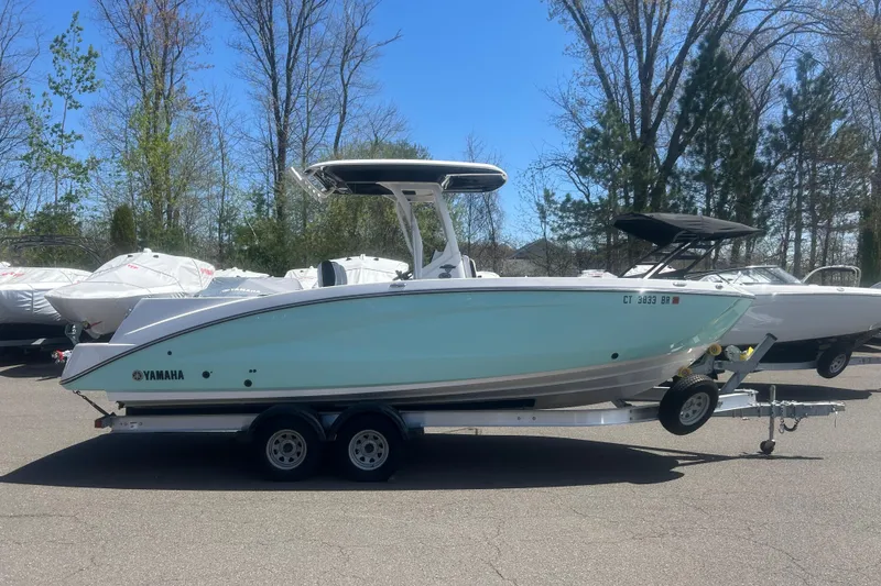Slide: The Image of 2024 Yamaha Boats 252 FSH Sport on trailer, parked outdoors. - 4