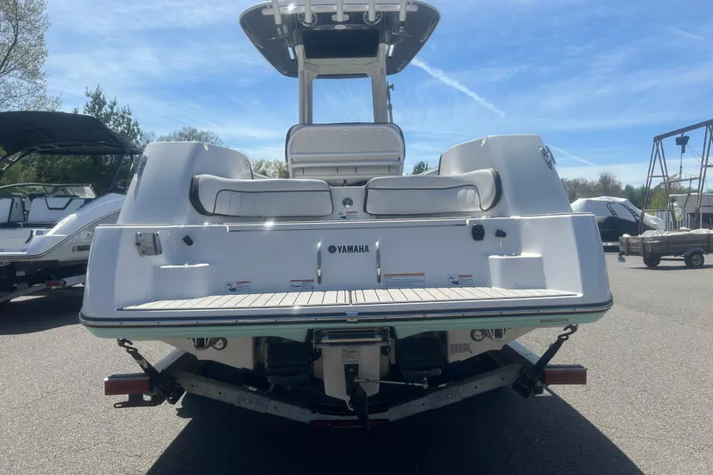 Slide: The Image of 2024 Yamaha Boats 252 FSH Sport, rear view, showcasing sleek design and spacious seating. - 6