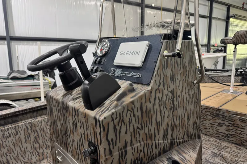 Slide: The Image of 2025 Xpress H190B Bay boat console with Garmin navigation system in a showroom. - 3