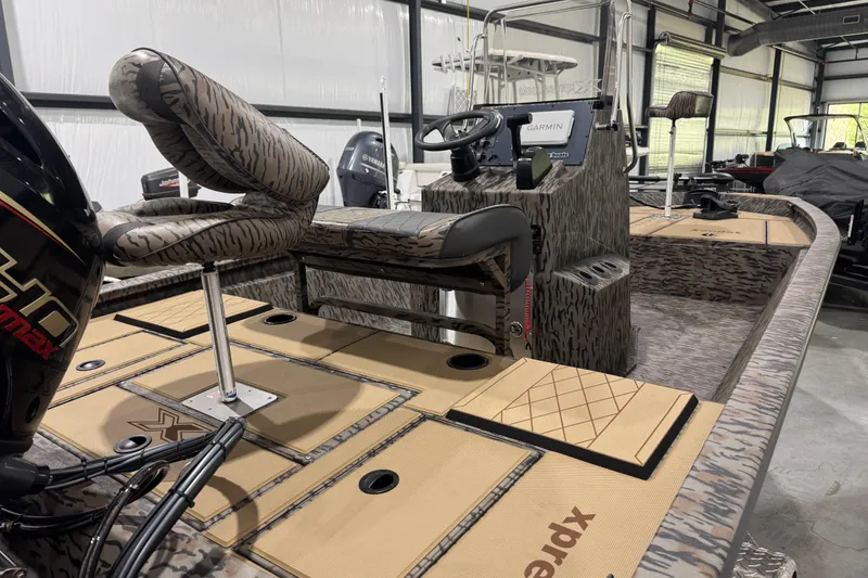 Slide: The Image of 2025 Xpress H190B Bay boat interior with camouflage seating and advanced controls. - 4