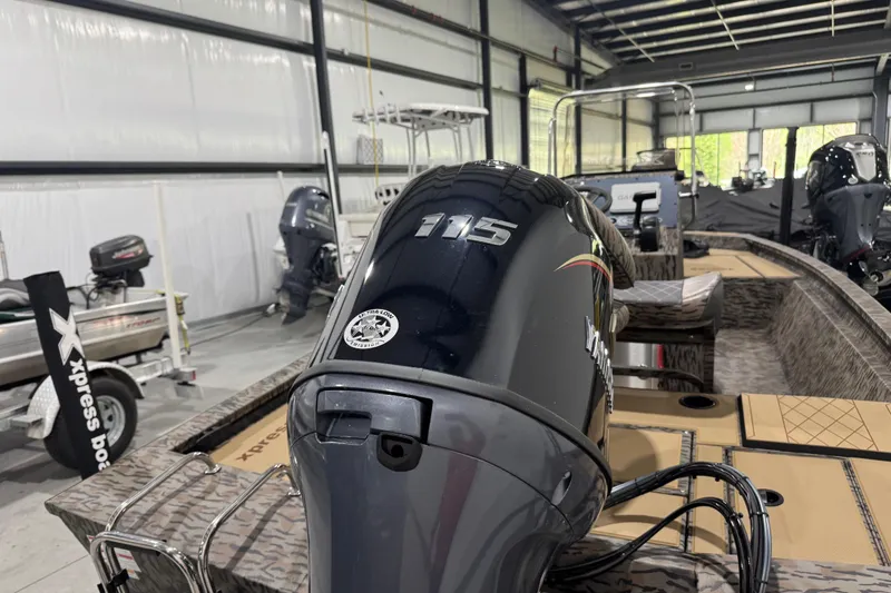 Slide: The Image of 2025 Xpress H190B Bay boat with 115 horsepower engine in a showroom. - 5