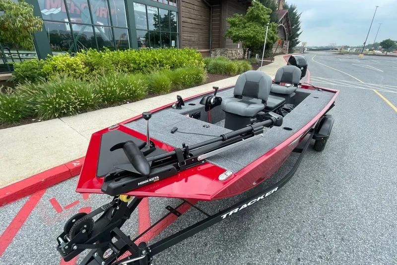 Slide: The Image of 2026 Tracker Panfish 17 boat in parking lot, featuring Minn Kota trolling motor. - 3