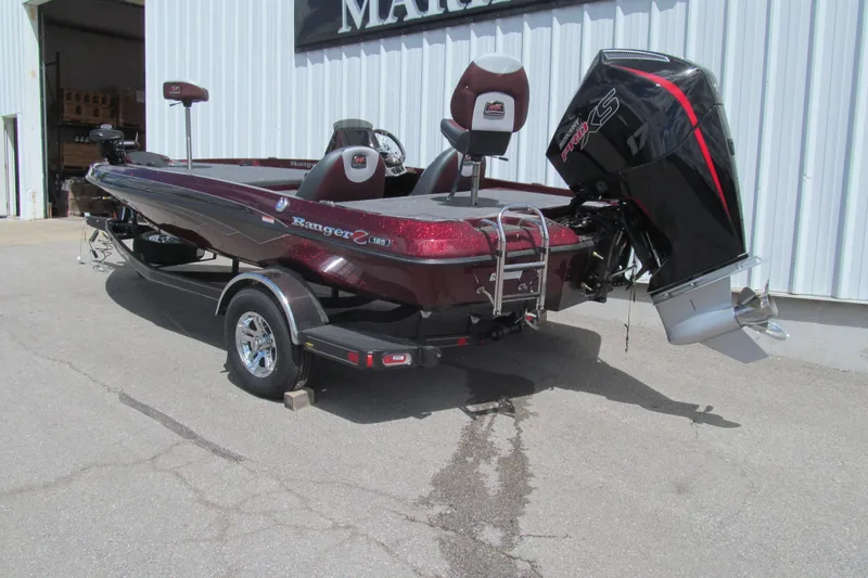 Slide: The Image of 2026 Ranger Z185 boat with powerful outboard motor, parked outside a building. - 2