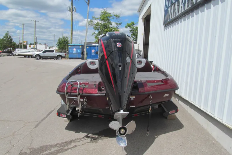 Slide: The Image of 2026 Ranger Z185 boat with powerful outboard motor, parked outside a marine shop. - 3