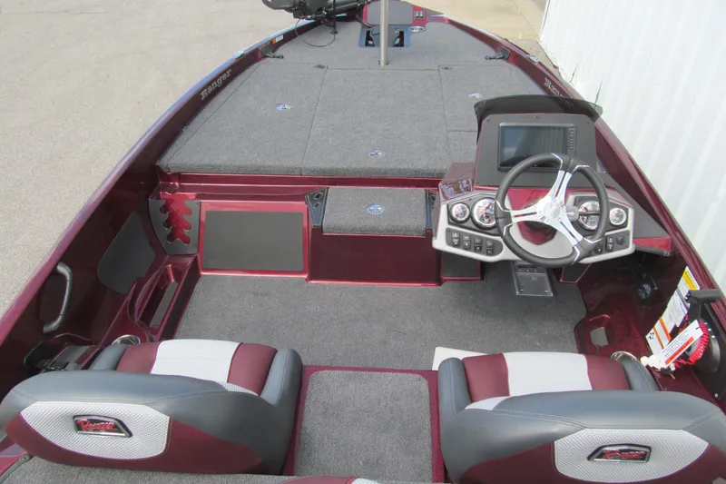 Slide: The Image of 2026 Ranger Z185 boat interior with steering console, plush seating, and modern dashboard controls. - 4