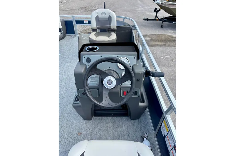 Slide: The Image of 2026 Sun Tracker Bass Buggy 18 DLX steering console with gauges and controls. - 2