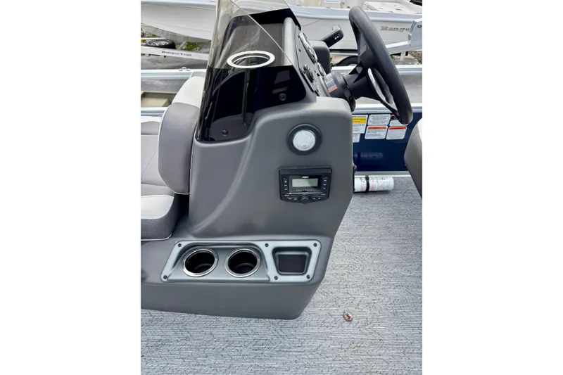 Slide: The Image of 2026 Sun Tracker Bass Buggy 18 DLX console with steering wheel and cup holders. - 3