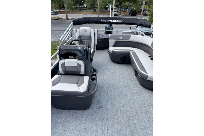 Slide: The Image of 2026 Sun Tracker Bass Buggy 18 DLX pontoon boat interior with seating and helm. - 4
